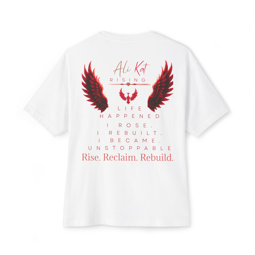 Introducing the Phoenix Season: Vol. 1 Signature Oversized Tee by AliKat Rising—an oversized unisex t-shirt crafted from premium heavyweight white cotton. This standout tee features bold red and black wings artwork and inspiring text: “Life happened. I rose. I rebuilt. I became. Unstoppable. Rise. Reclaim. Rebuild.” The back displays “AliKat Rising,” making this the ultimate symbol of rising above challenges and a must-have from the Phoenix Season collection.