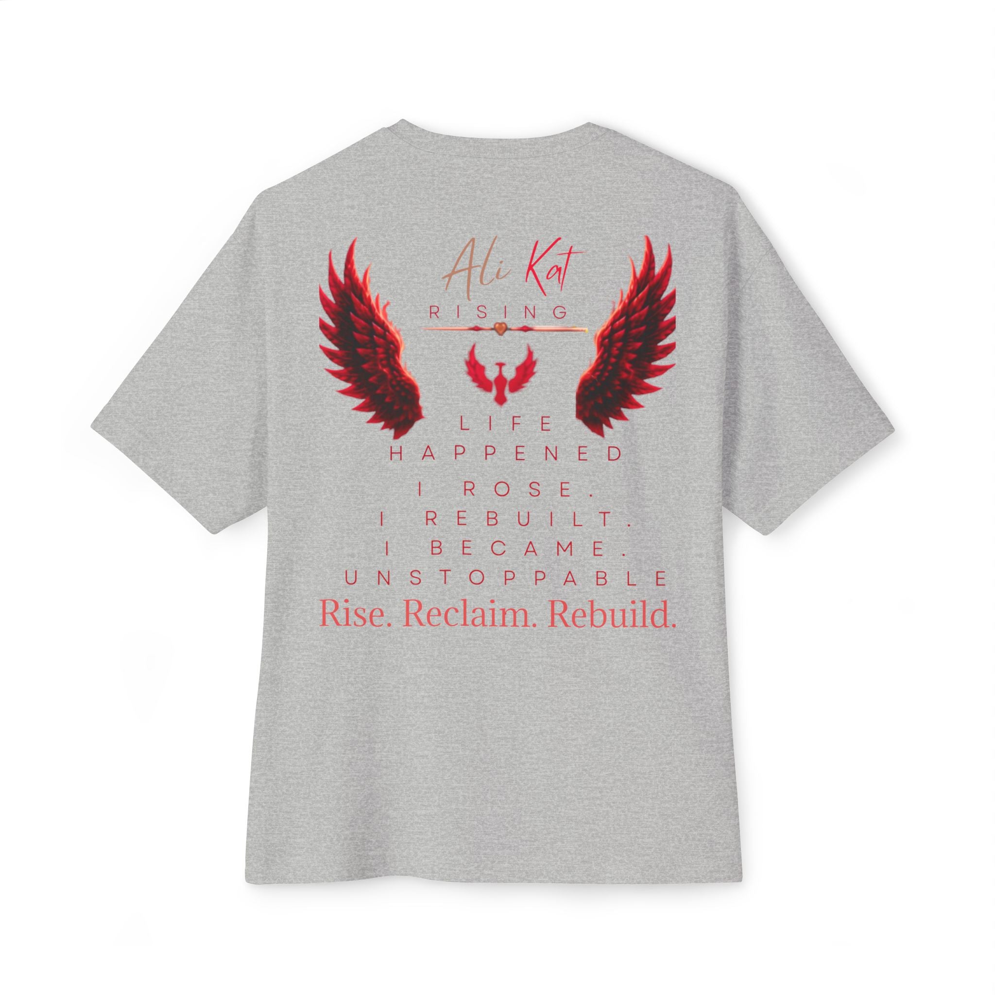 Introducing the Phoenix Season: Vol. 1 Signature Oversized Tee from AliKat Rising—expertly crafted from premium heavyweight cotton and designed with an oversized unisex fit. The back features a bold red and black wings graphic, accented by motivational text: "AliKat Rising. Life happened. I rose. I rebuilt. I became unstoppable. Rise. Reclaim. Rebuild."—all powerfully centered to make a striking statement.