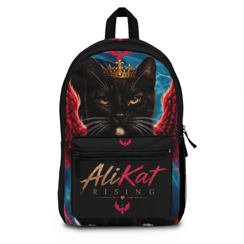 Discover the Phoenix Vol. 1 Backpack | AliKat Rising by AliKat Rising, an art-inspired backpack featuring a crowned black cat with striking red wings and bold "AliKat Rising" text on the front pocket, set against a vibrant blue and black backdrop.