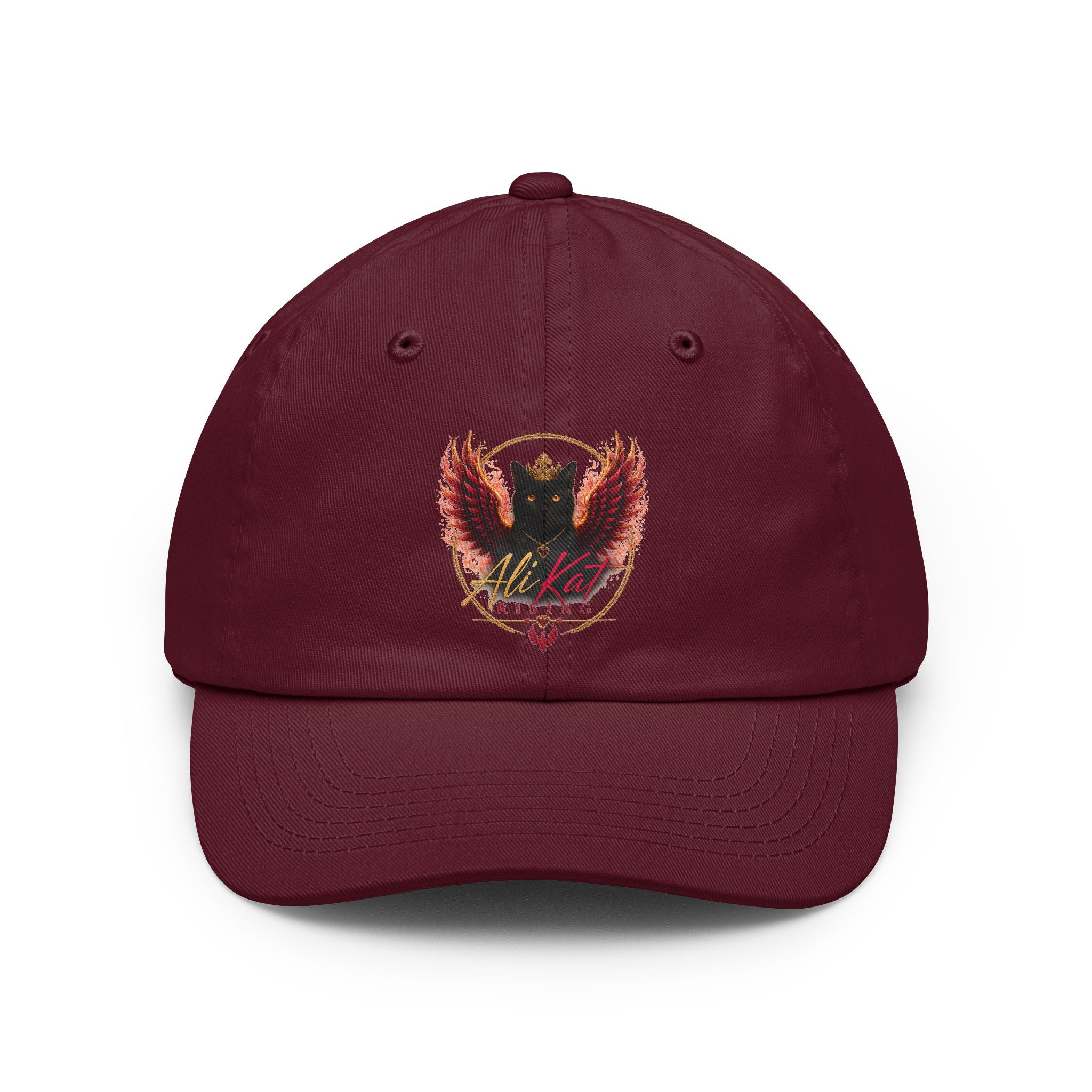The AliKat Rising Phoenix vol 1 dad hat by AliKat Rising is a maroon low-profile cap featuring an embroidered crest of a black cat with red-orange wings, a heart, and the word "Alikat" in cursive below the design.