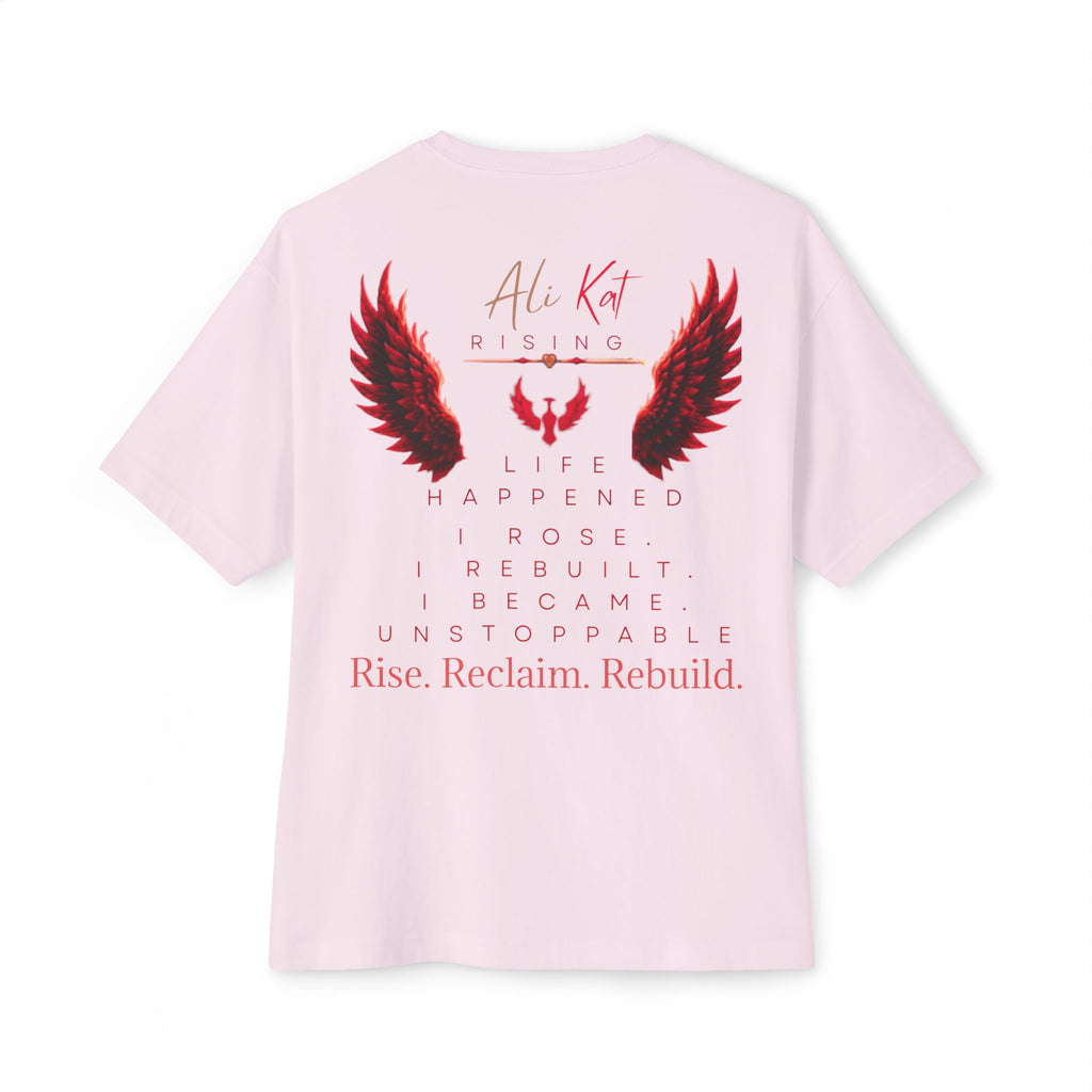 The Phoenix Season: Vol. 1 Signature Oversized Tee by AliKat Rising is crafted from premium heavyweight cotton in a light pink hue. This unisex oversized t-shirt features a bold red and black wings graphic along with the “Ali Kat Rising” text on the front, while the back showcases inspiring phrases—“Life happened. I rose. I rebuilt. I became unstoppable. Rise. Reclaim. Rebuild.” Combining comfort with motivating energy, it’s designed for your everyday rise.