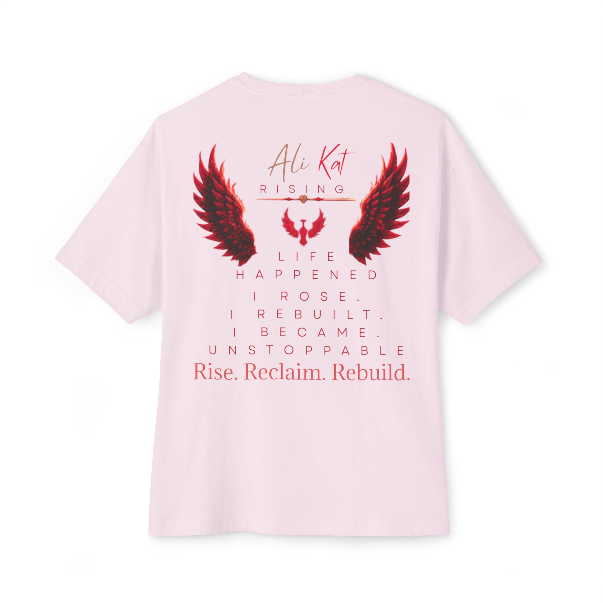 The Phoenix Season: Vol. 1 Signature Oversized Tee by AliKat Rising is crafted from premium heavyweight cotton in a light pink hue. This unisex oversized t-shirt features a bold red and black wings graphic along with the “Ali Kat Rising” text on the front, while the back showcases inspiring phrases—“Life happened. I rose. I rebuilt. I became unstoppable. Rise. Reclaim. Rebuild.” Combining comfort with motivating energy, it’s designed for your everyday rise.