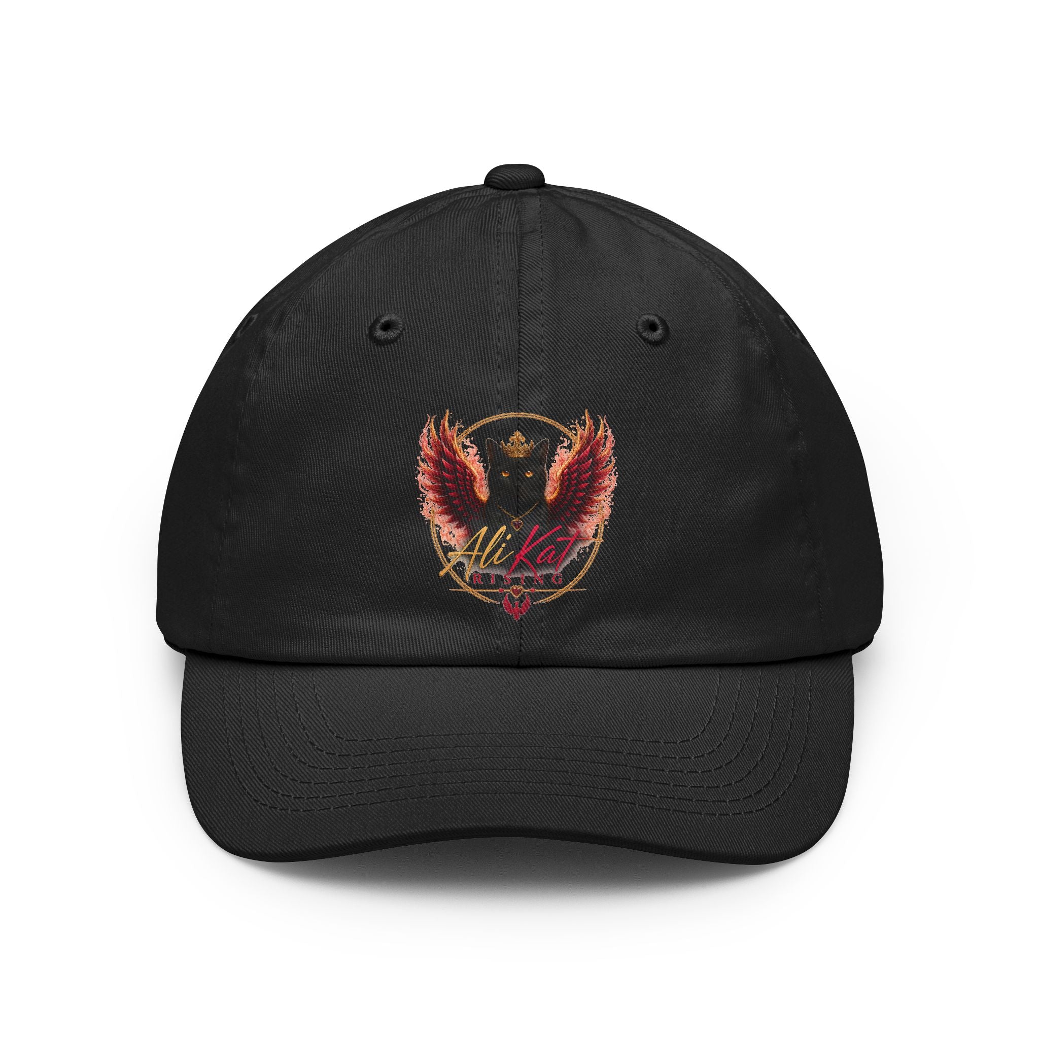 The AliKat Rising Phoenix vol 1 dad hat by AliKat Rising is a black, low-profile cap featuring an embroidered red and gold phoenix rising above a gold shield crest, with stylized text underneath. The hat is displayed from the front on a white background.