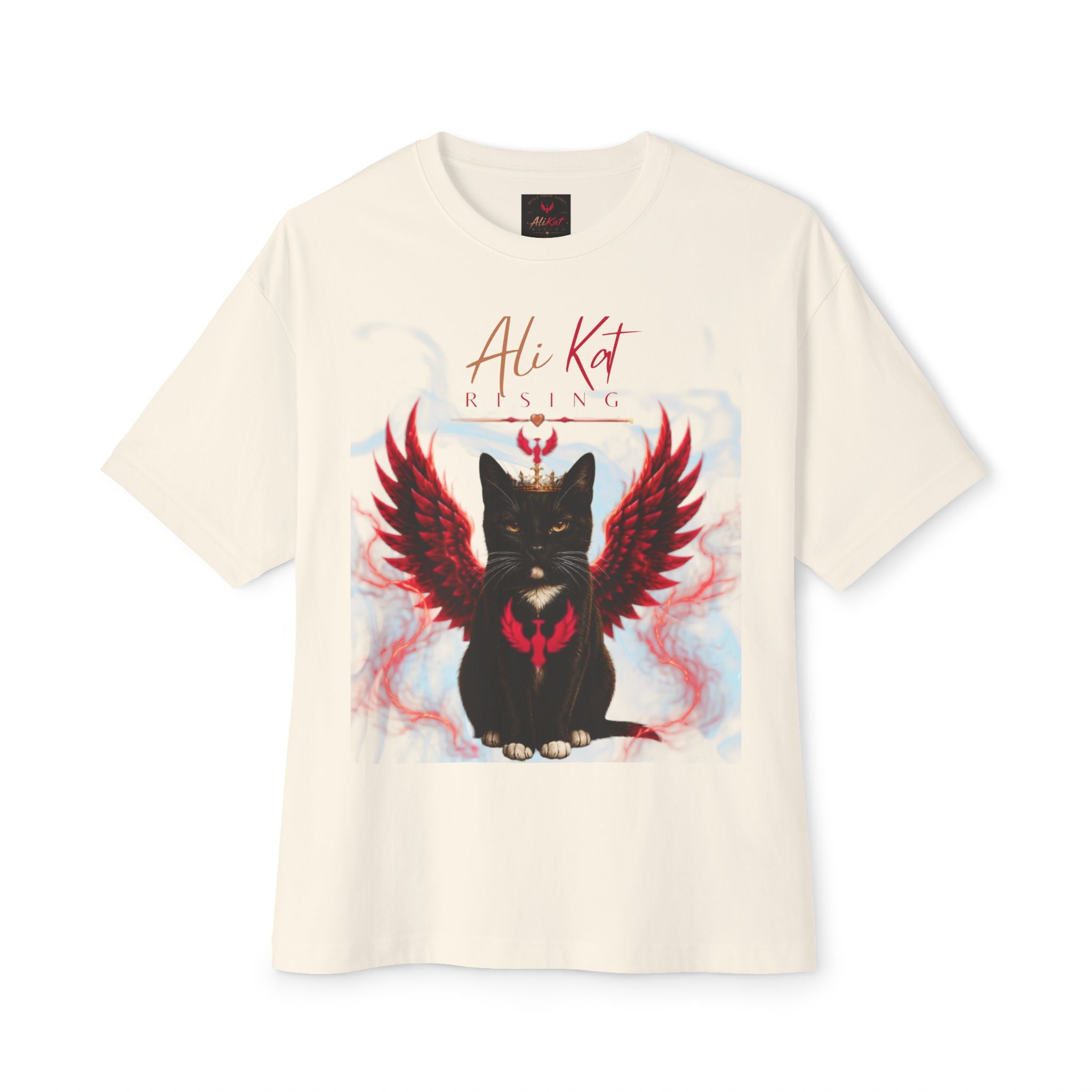 Introducing the Phoenix Season: Vol. 1 Signature Oversized Tee by AliKat Rising—a premium heavyweight white cotton t-shirt showcasing a striking black cat with red, fiery wings and a heart-shaped marking on its chest. Bold red script above the design reads "Ali Kat RISING." This unisex oversized tee is the ultimate statement piece for fans of Phoenix Season.