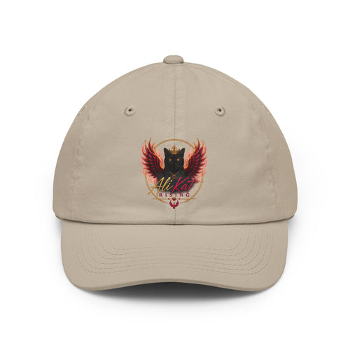 Introducing the AliKat Rising Phoenix vol 1 dad hat by AliKat Rising: a beige, low-profile cap adorned with an embroidered crest depicting a black cat with red wings and a crown, encircled by a golden ring. The stylized words "AliKat Rising" are stitched below the motif.