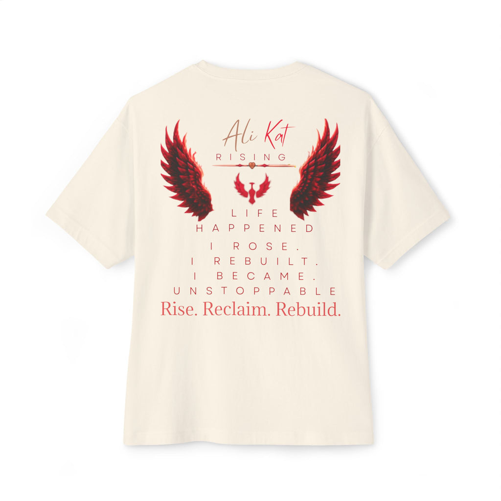 Introducing the Phoenix Season: Vol. 1 Signature Oversized Tee from AliKat Rising—a premium off-white unisex t-shirt crafted from heavyweight cotton and featuring bold red and black wings graphic. The oversized design displays the empowering text: AliKat Rising. Life happened. I rose. I rebuilt. I became unstoppable. Rise. Reclaim. Rebuild.