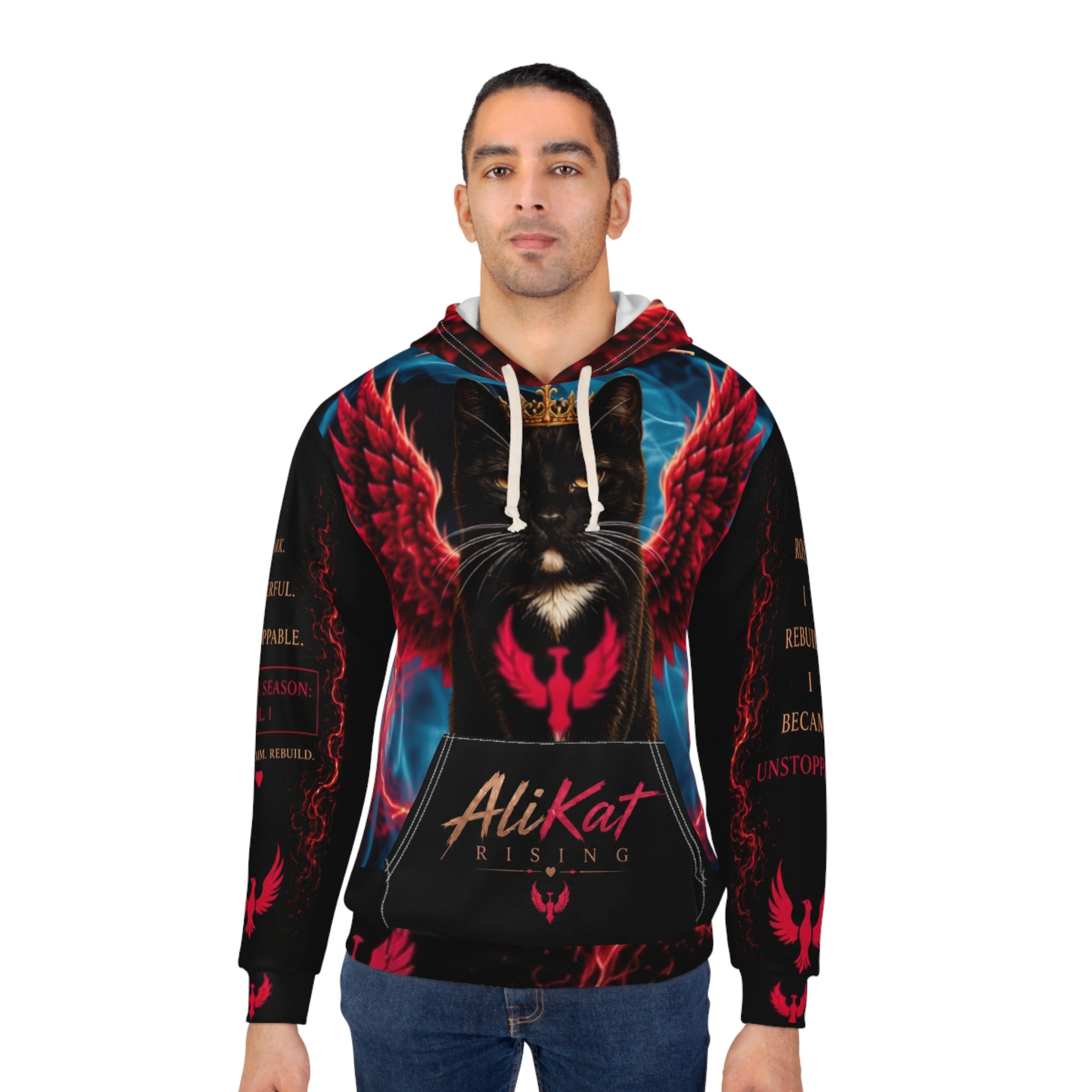A man wearing the Phoenix Vol. 1 Premium Motivational Hoodie by AliKat Rising, featuring a striking black cat with red wings, glowing eyes, and the “AliKat Rising” text. The bold and vibrant design extends to red wing graphics on the sleeves. Available in XS through 2XL—see our size chart for your ideal fit and clothing length.
