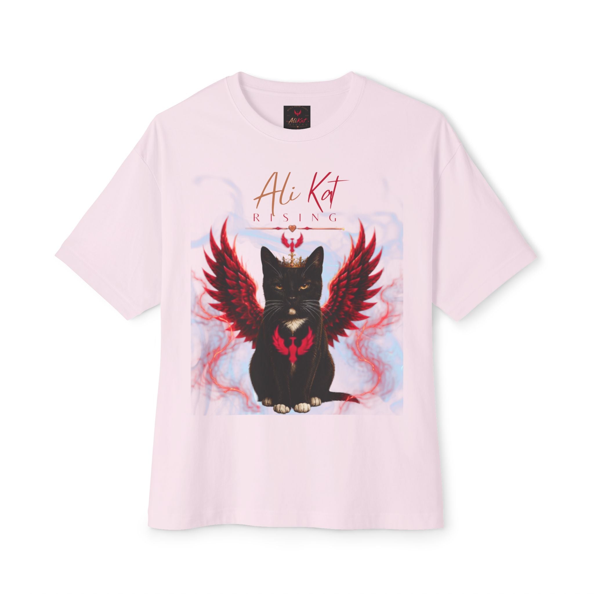Introducing the Phoenix Season: Vol. 1 Signature Oversized Tee by AliKat Rising—a light pink unisex t-shirt crafted from premium heavyweight cotton. This standout tee features a black cat with bold red, flame-inspired wings and a vivid red phoenix emblem, topped with the stylish "AliKat Rising" text above the graphic.