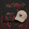 A Rise Bundle from AliKat Rising, featuring a black Phoenix Vol. 1 Graphic Tee, a beige Phoenix Vol. 1 Dad Hat, and an AliKat Rising notebook with a red and black winged cat design, is displayed on a matching themed background adorned with gold chains and a red wallet.